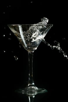 martini splash on black background close up