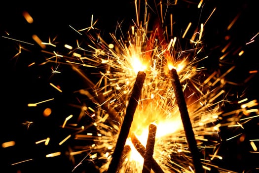 yellow sparkler holiday background on black