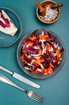 Diet chicory salad with grapefruit and pine nuts on a plate. Flat lay.