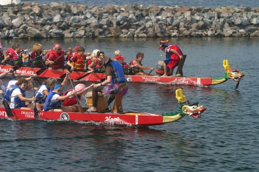 Dragon boat races on Lake Champlain in Burlington, Vermont, USA.  The races are held to raise money for breast cancer survivors.