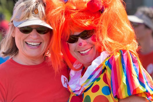 Two women dress up for the Dragon Boat races held world wide to raise money for breast cancer survivors.  Burlington, Vermont.