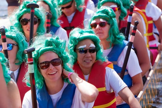 Dragon boat racers before a race. Dragon boat races in Burlington, Vermont, USA.  The races are held to raise money for breast cancer survivors.
