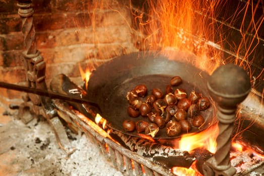 Chestnuts roasting on an open fire.  Weathersfield Inn, Weathersfield, VT.  New England USA