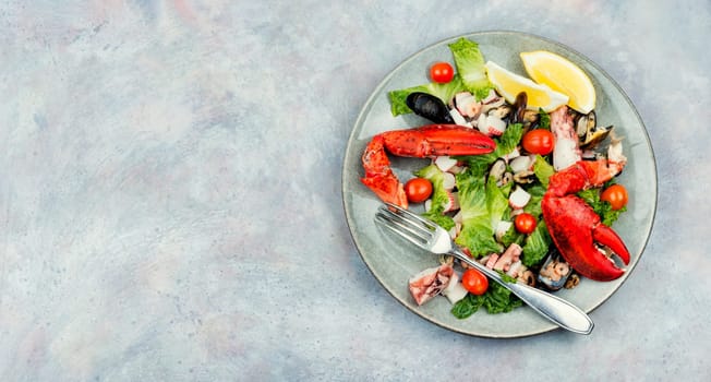 Appetizing salad of oysters, mussels, lobster and vegetables.