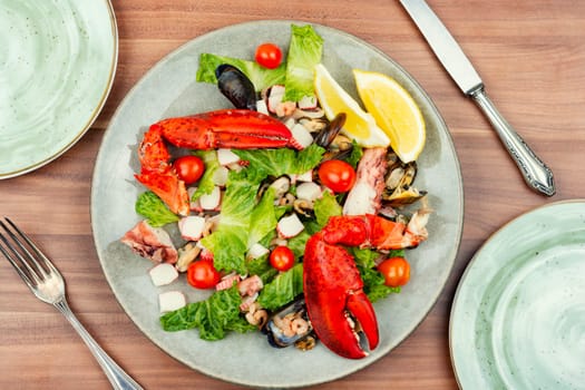 Appetizing salad of oysters, mussels, lobster and vegetables.