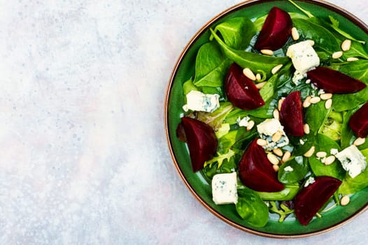 Tasty salad with beets, blue cheese, herbs and pine nuts.