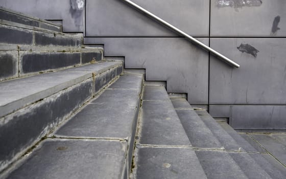 Detail of modern exterior staircase in the city, decorated with natural stone