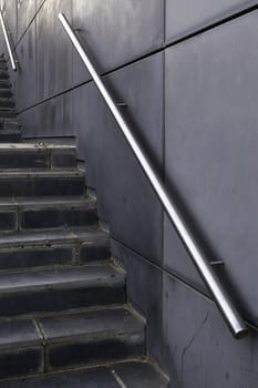 Detail of modern exterior staircase in the city, decorated with natural stone