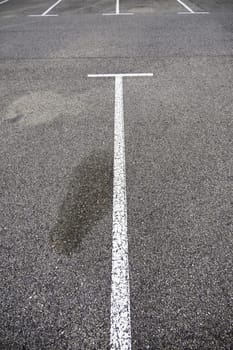 Detail of parking lines in a public parking lot, road signs