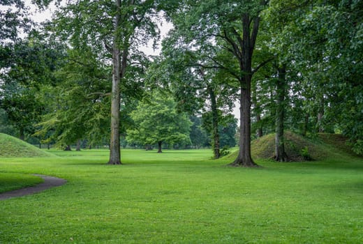 Entrance to the Great Circle at the Newark Earthworks built by prehistoric indigenous people in Ohio. Break in the circle opens to the interior. Green grass, sunny outdoors with no people and copy space.