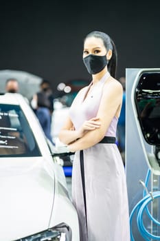 Nonthaburi, Thailand - DEC 4, 2021 - Unidentified model poses with a car at The 38th Motor Expo Thailand 2021 at IMPACT Arena, Muang Thong Thani, Nonthaburi, Thailand.