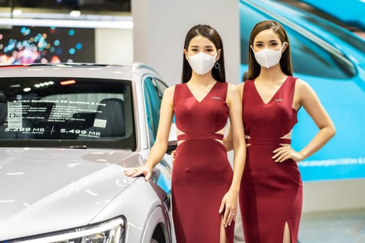 Nonthaburi, Thailand - DEC 4, 2021 - Unidentified model poses with a car at The 38th Motor Expo Thailand 2021 at IMPACT Arena, Muang Thong Thani, Nonthaburi, Thailand.