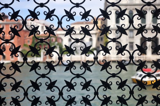 Detail of an ancient window with grating in wrought iron. Venice, Italy