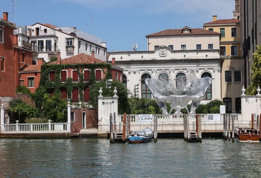 Venice, Italy - September 5, 2022: Baby 3.0 the monumental sculpture by Lorenzo Quinn in the garden of Ca’ Corner della Ca’ Granda palace in Venice.