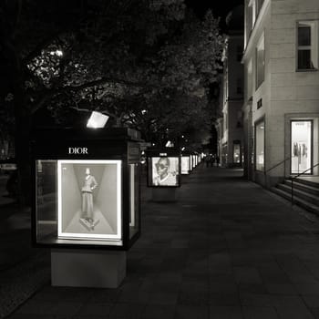 illuminated outdoor advertisement of french designer Dior on Kurfuerstendamm in Berlin by night