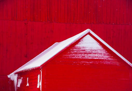 A red barn with snow in Vermont, USA