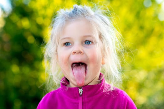 little nice girl in front of nature background is happy