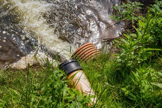 Pipe with spill water at a lake