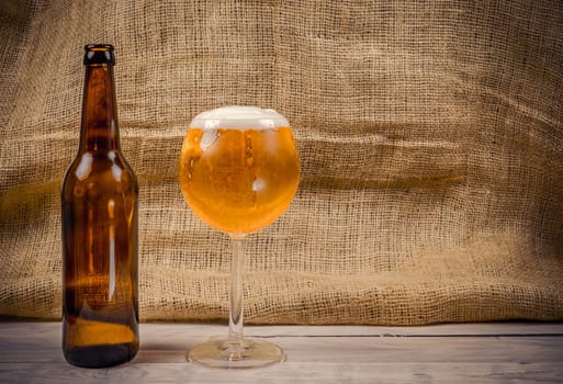 Beer in a glass on a wooden table