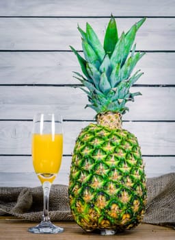 Juice from a pineapple on a wooden table