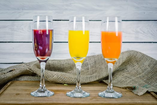 Colorful juice variations on a wooden table