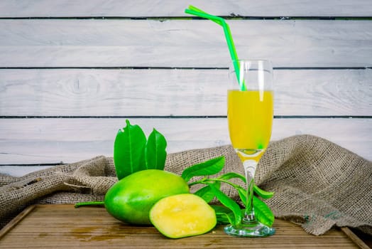 Green mango juice on a wooden table