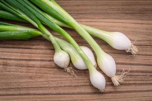 Scallions on a dark wooden table