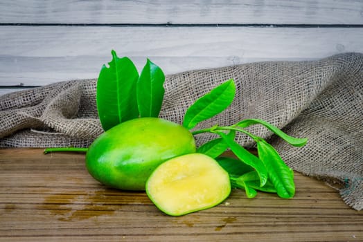 Green mango on a wooden table