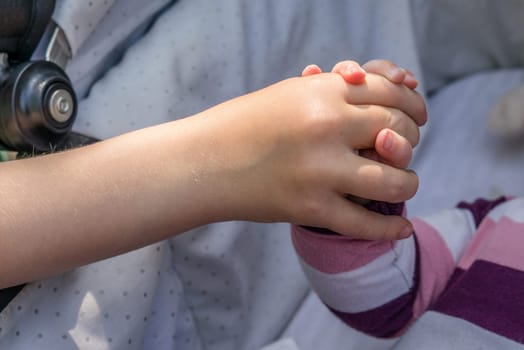 Close-up of a small baby holding a hand