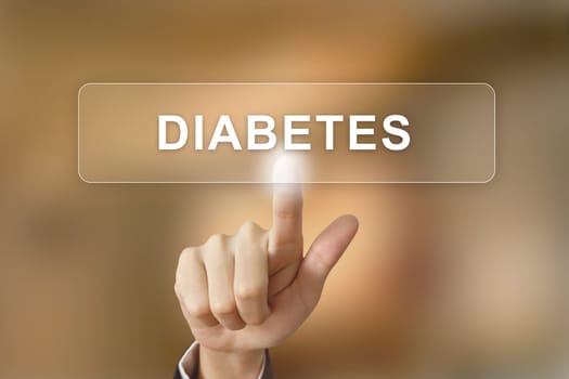 hand pushing diabetes button on blurred background