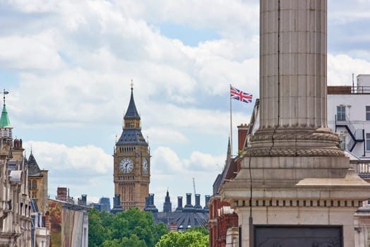 Cropped cityscape with Big Ben prominent in the background on a cloudy summer day in London, UK.