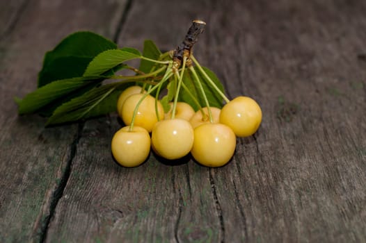 cluster of white sweet cherry on an old board, the image of summer berries