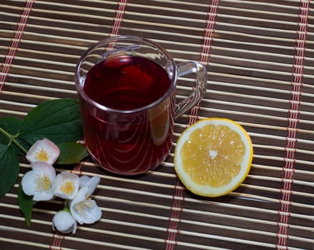 the transparent glass of red juice and lemon, still life on a subject drinks