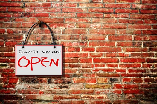 come in we are open hanging sign isolated on wall for adv or others purpose use