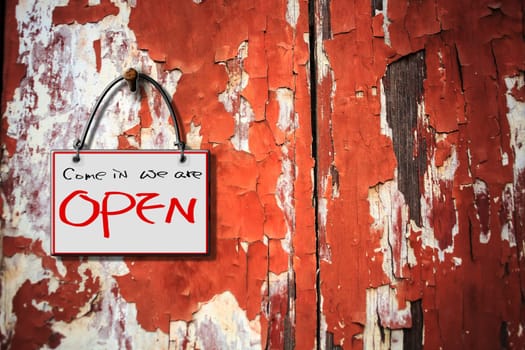 come in we are open hanging sign isolated on wall for adv or others purpose use