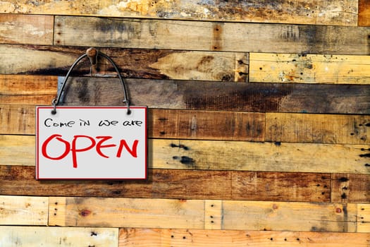 come in we are open hanging sign isolated on wall for adv or others purpose use
