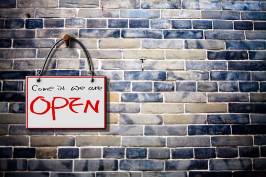 come in we are open hanging sign isolated on wall for adv or others purpose use