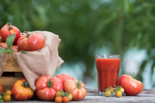 Fresh tomato juice, on a wooden background