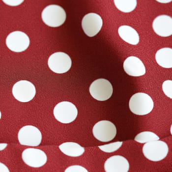 White polka dots on red background, textile fabric surface background