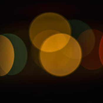 Multicolored abstract round bokeh - beige, orange, yellow, red. Bokeh is the blurring of an out-of-focus lens in a photograph. Festive blurred background