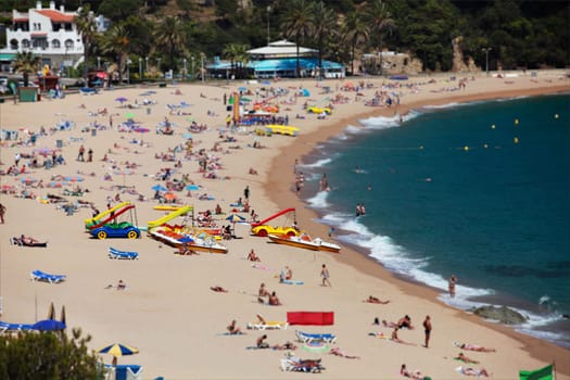 beach, many people relax and sunbathe on the shores of the warm sea, summer lagoon, palm trees