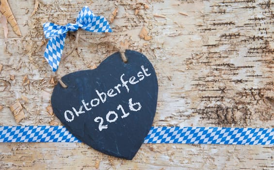 Rustic background made of birch bark with heart of slate