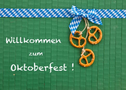 Small pretzels on a green background with white and blue gift ribbon