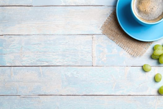 coffee cup with grapes and a wooden background
