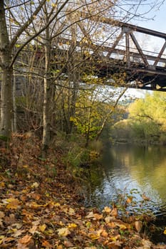 Old iron bridge over the river Eder with banks and trees in Hesse, Germany, Europe