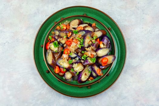 Grilled eggplant salad with parsley, garlic and tomato. Warm salad