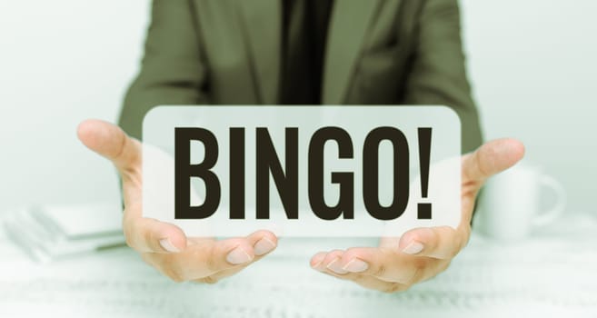 Writing displaying text Bingo, Business approach game of chance in which each player matches numbers printed