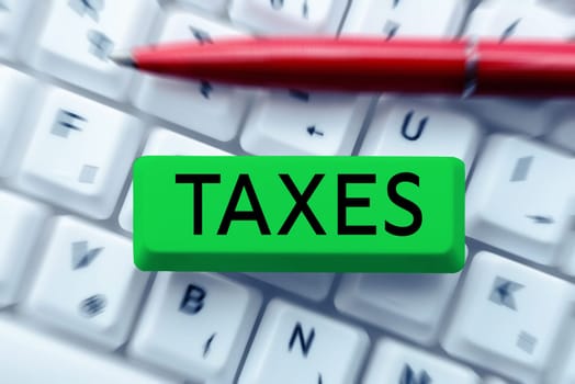 Writing displaying text Taxes, Internet Concept contribution to state revenue levied by government on workers income