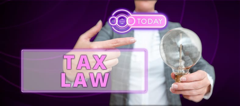 Hand writing sign Tax Law, Conceptual photo governmental assessment upon property value or transactions