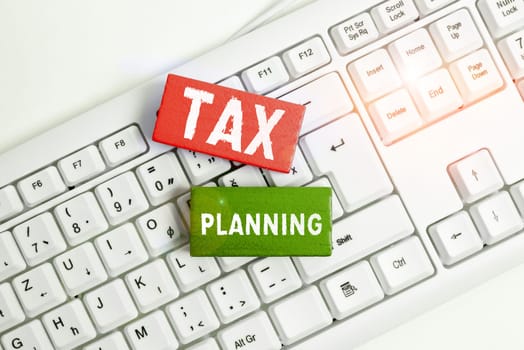 Hand writing sign Tax Planning, Business idea analysis of financial situation or plan from a tax perspective